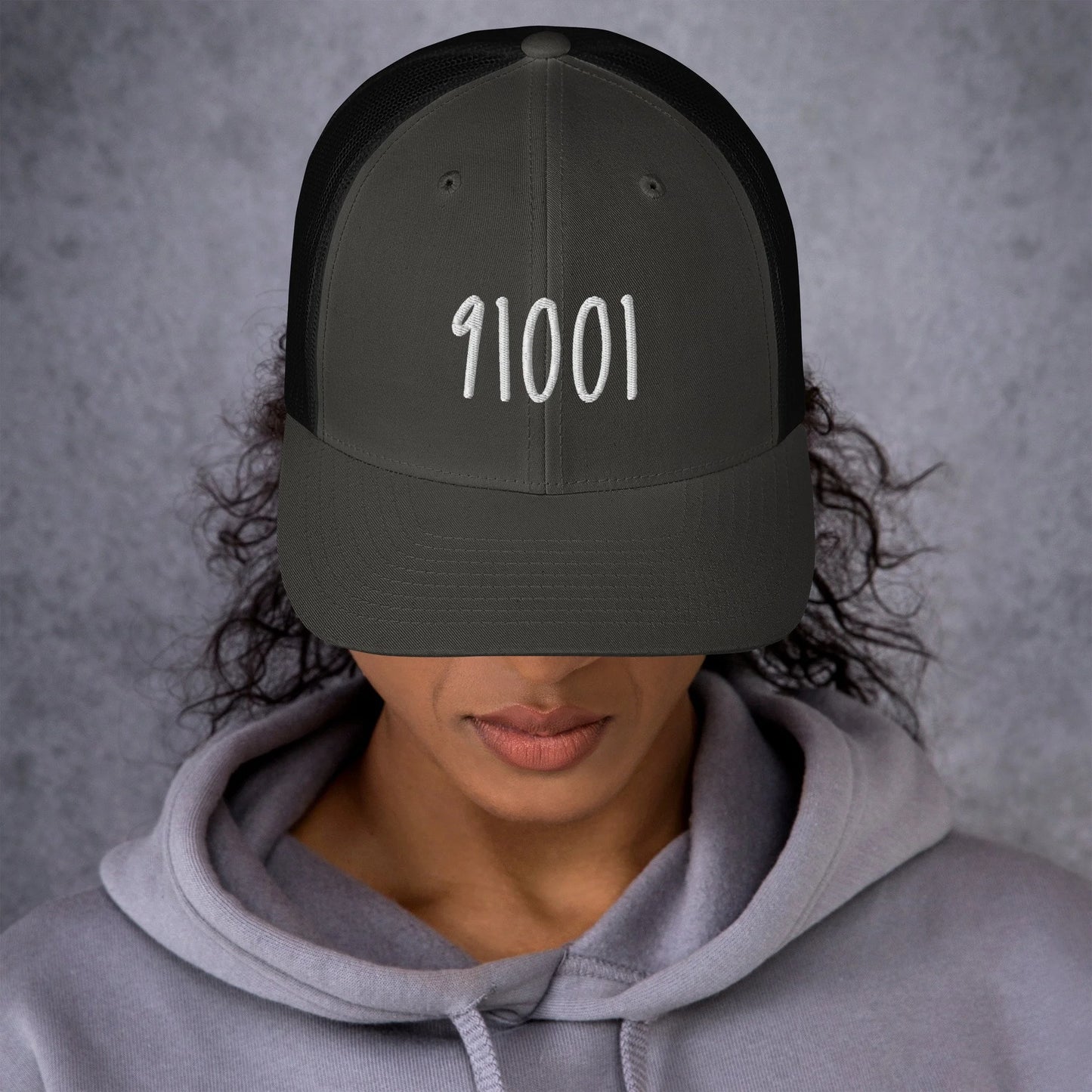 Model wearing the charcoal 91001 trucker hat