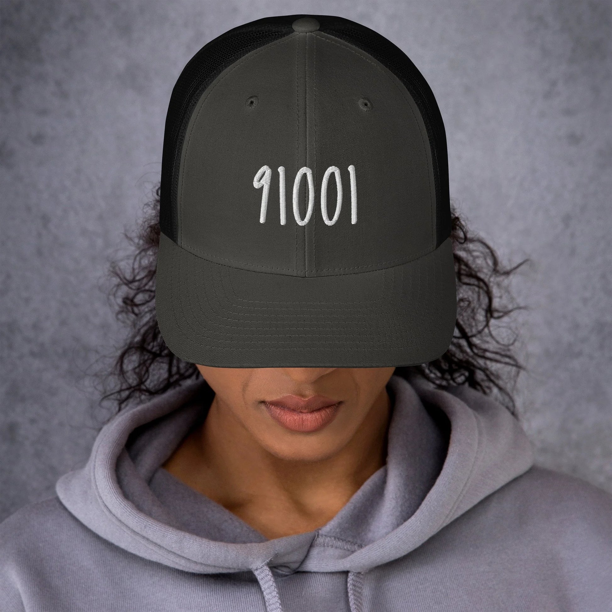 Model wearing the charcoal 91001 trucker hat