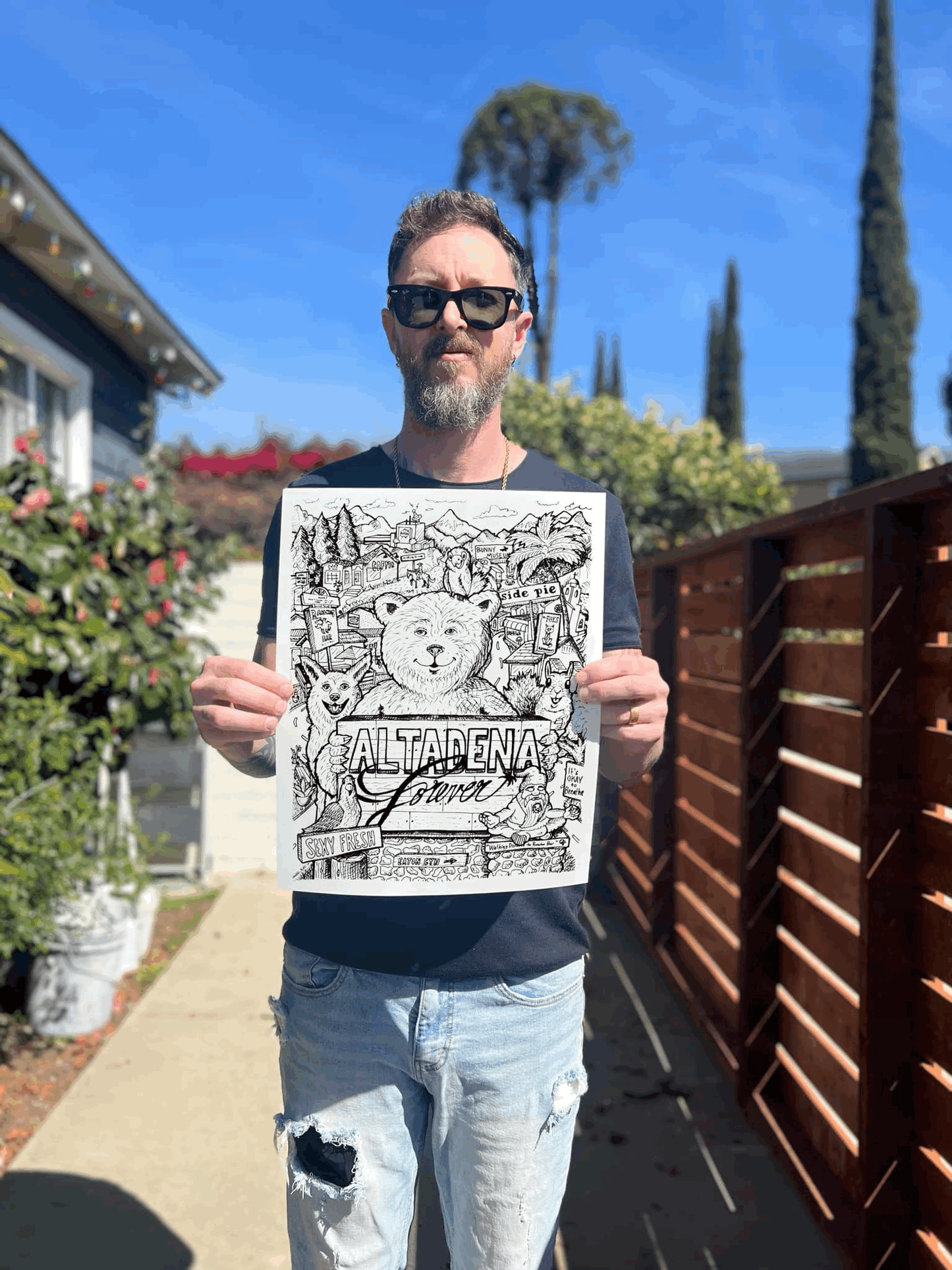 Person holding the Altadena Forever black-and-white print outdoors