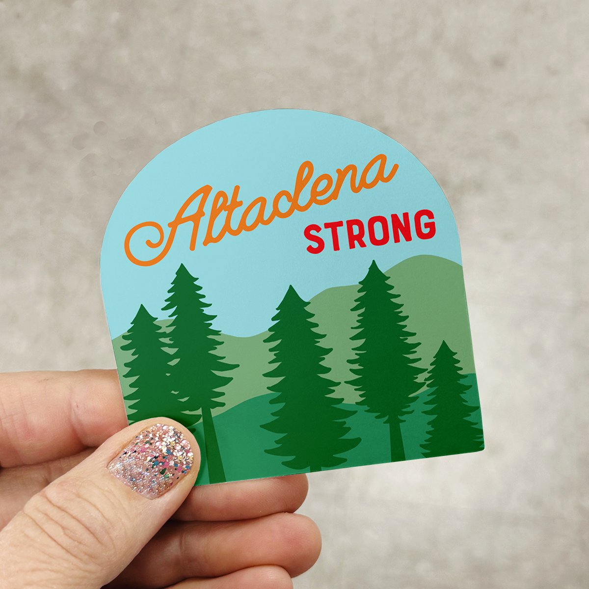 Altadena Strong vinyl sticker held in a hand