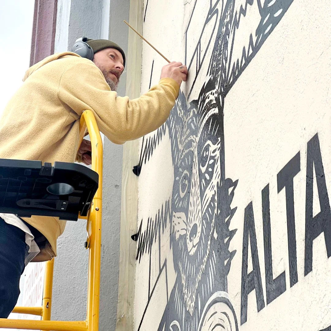 Artist painting the Beautiful Altadena mural