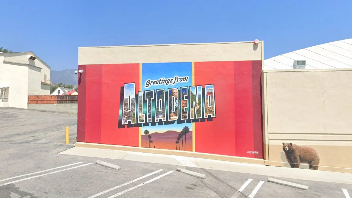 Greetings From Altadena mural poster shown painted on an exterior wall