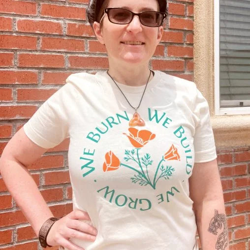 Model wearing the We Burn We Grow We Build T-shirt