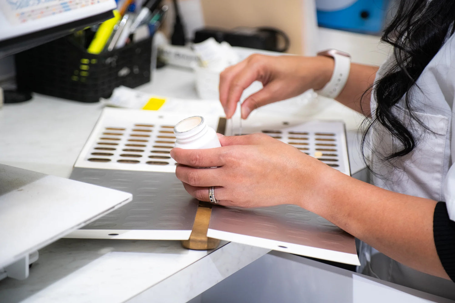 Team member preparing a prescription at the counting tray.
