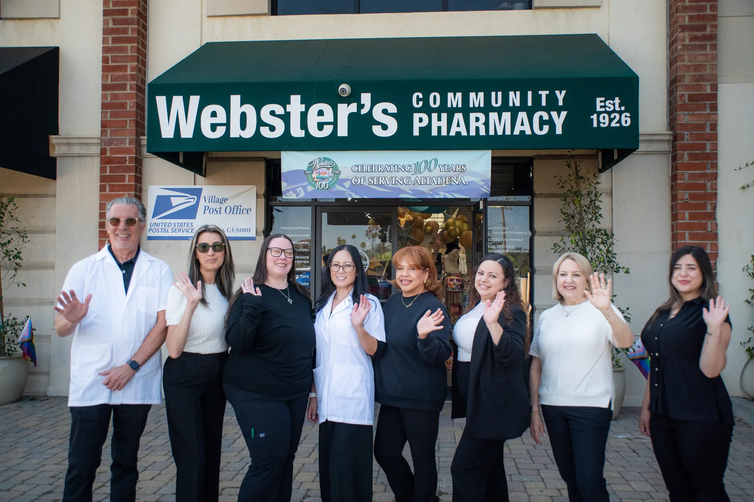 Full team portrait outside Webster's Community Pharmacy.