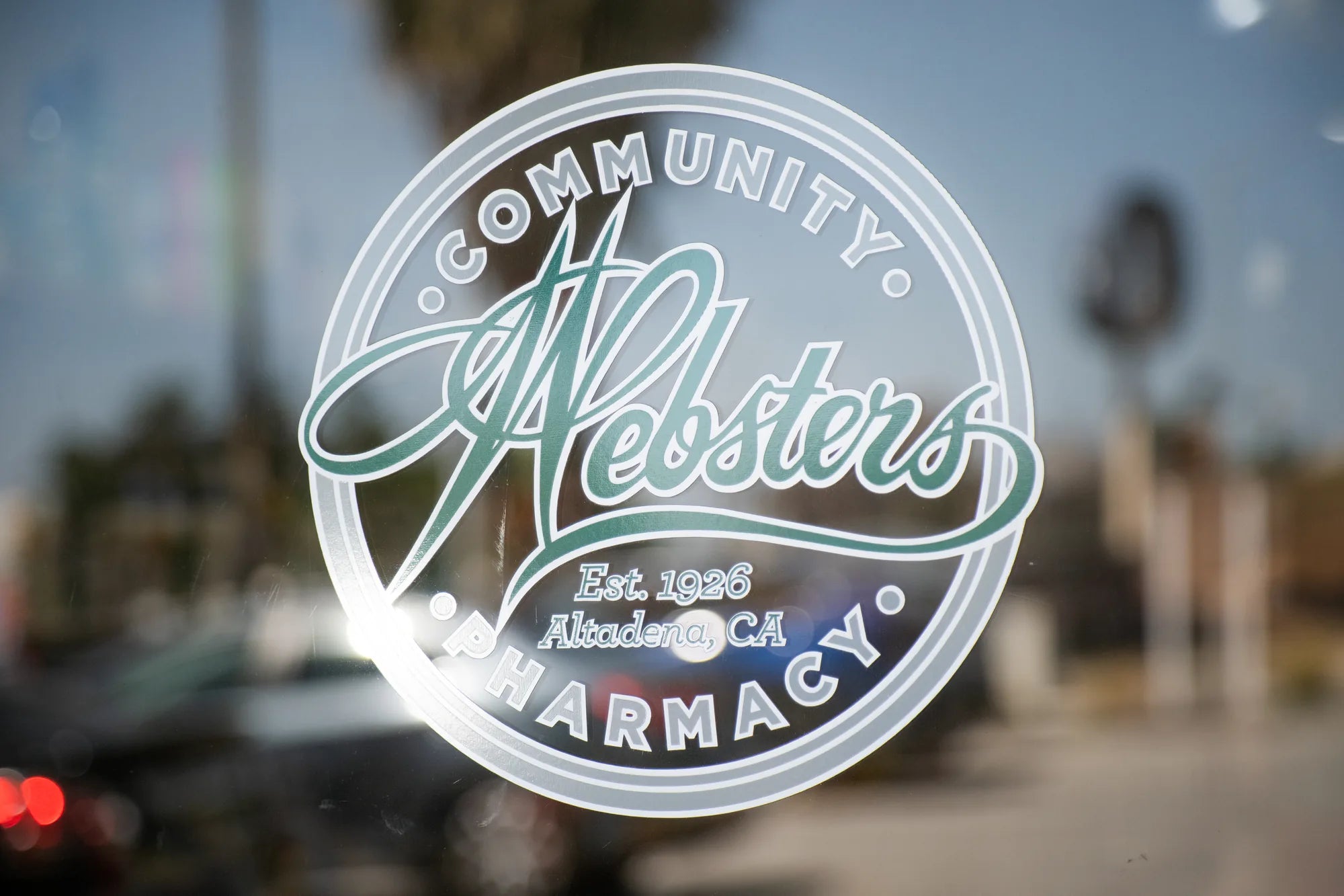 Webster's Community Pharmacy logo on the front window.