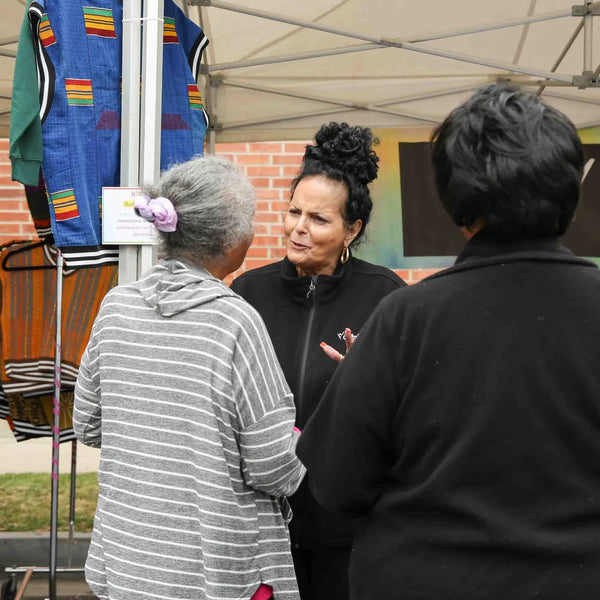 Guests chatting at an apparel booth during Webster's anniversary celebration