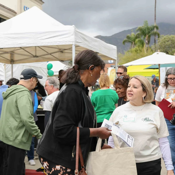 Attendees mingling among vendor booths at Webster's 100th anniversary fair in Altadena