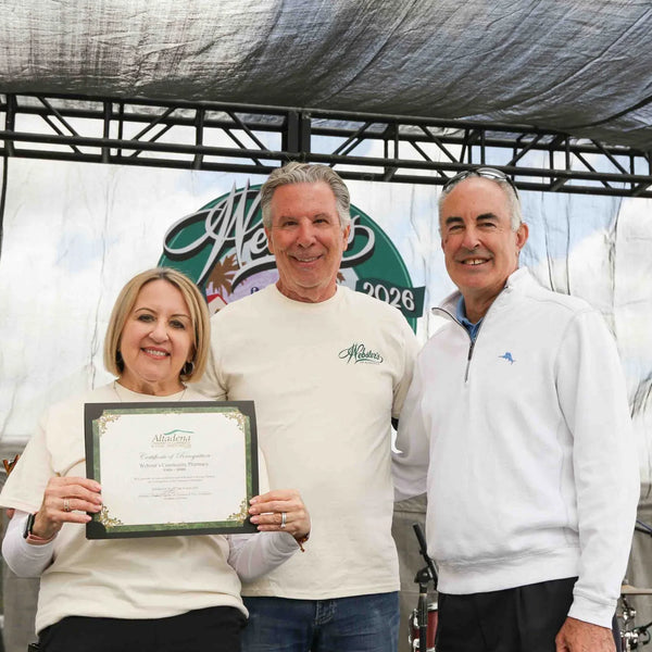 Award presented to Webster's Community Pharmacy during the centennial stage program