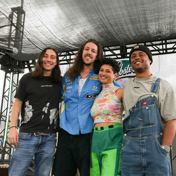 Band members posing together on stage at Webster's 100th anniversary celebration