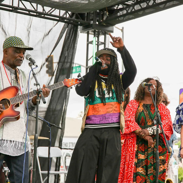 Band singing together on stage at Webster's centennial street fair