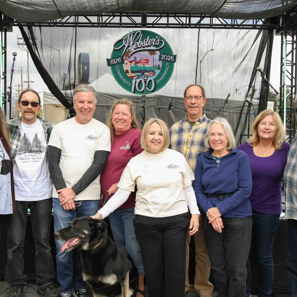 Community members posing in front of the stage at Webster's centennial street fair