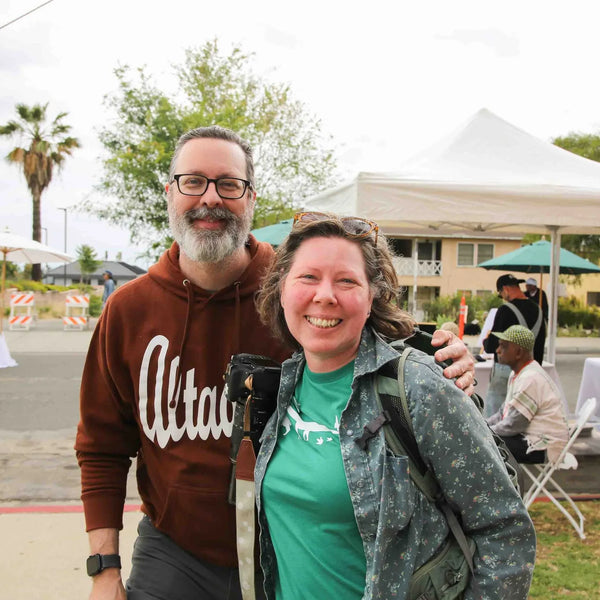 Couple in Altadena gear smiling at Webster's centennial street fair