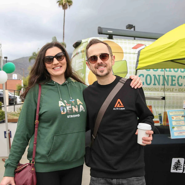 Couple in Altadena gear with coffee at Webster's 100th anniversary fair