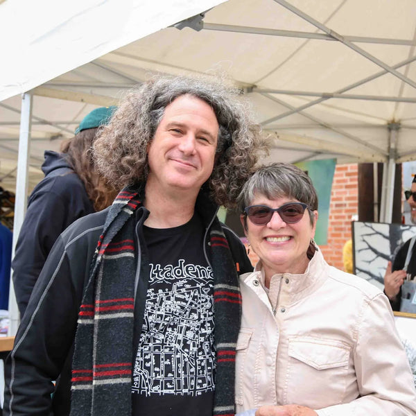 Couple smiling at an art booth during Webster's 100th anniversary fair