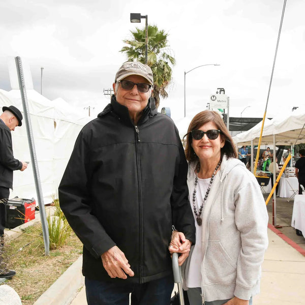 Couple strolling the vendor tents at Webster's Pharmacy centennial street fair