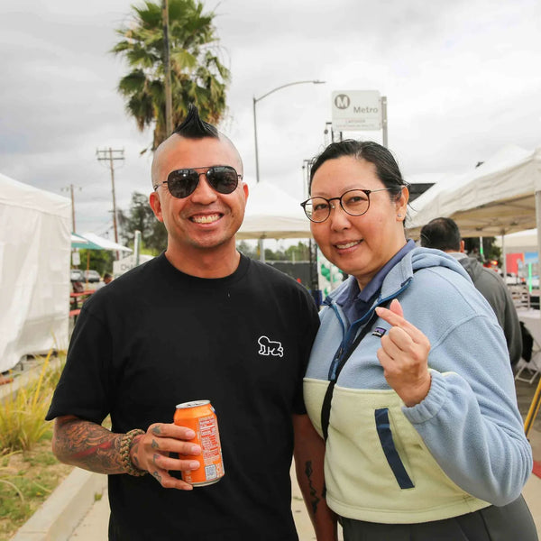 Couple sharing a drink and a smile at Webster's centennial fair in Altadena