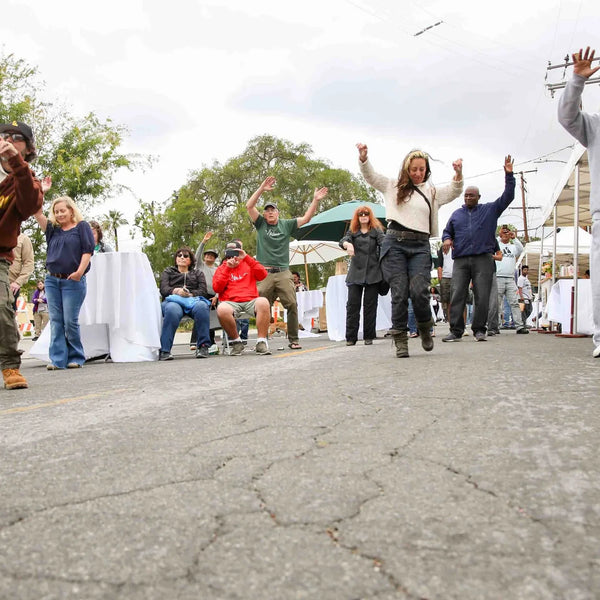 Attendees dancing in the street at Webster's centennial celebration
