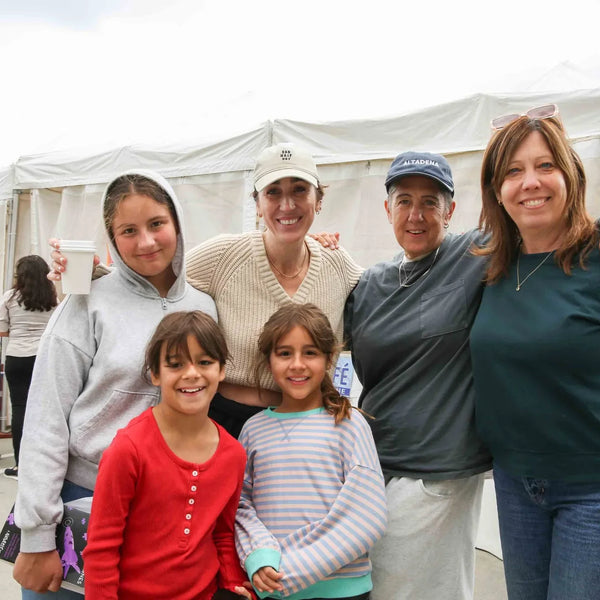 Family group posing by the exhibit tents at Webster's 100th anniversary fair