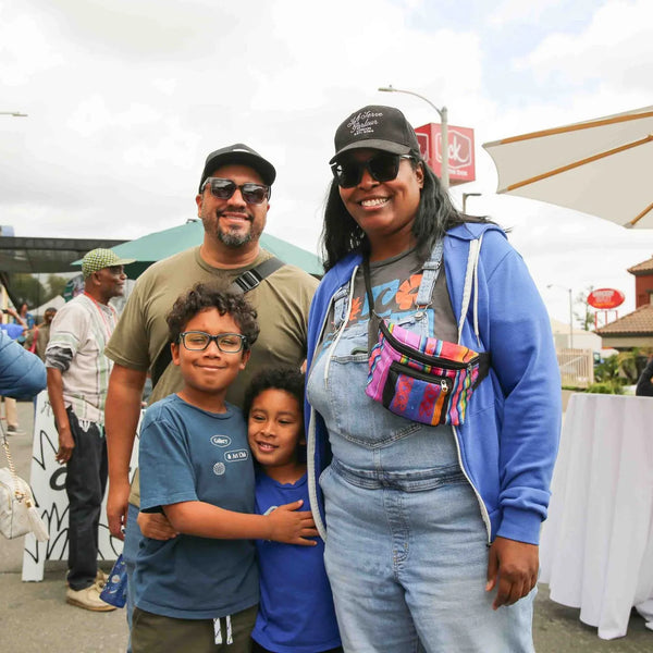 Family posing together at Webster's 100th anniversary street fair in Altadena