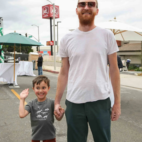 Father and son holding hands at Webster's anniversary fair in Altadena