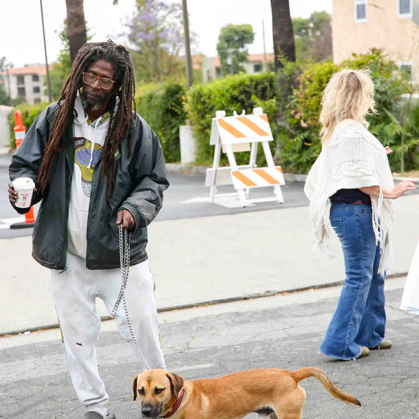 Guest walking his dog down the street at Webster's anniversary fair