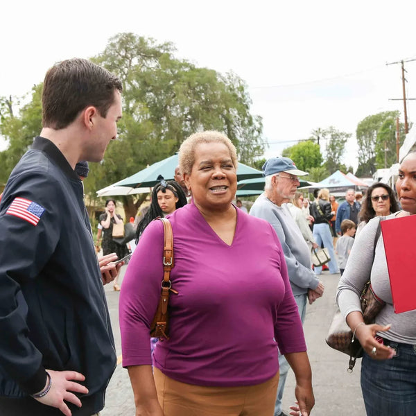 Guests chatting between booths at Webster's Pharmacy anniversary street fair