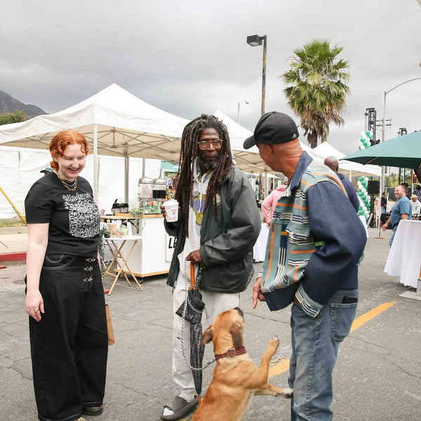 Guests greeting a dog in the street at Webster's centennial street fair