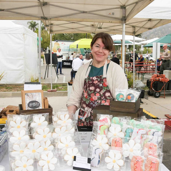 Vendor selling handmade flower-shaped soaps at Webster's 100th anniversary street fair