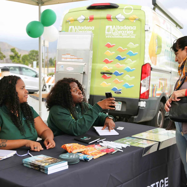Altadena Libraries outreach van and welcome table at Webster's 100th anniversary street fair