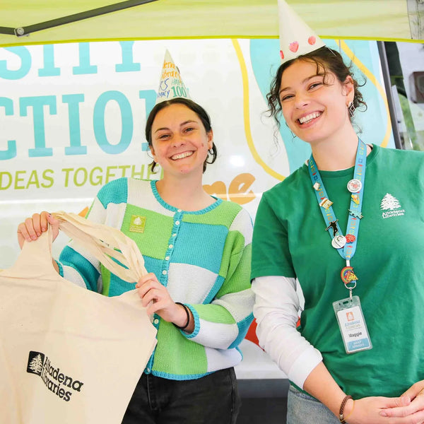 Altadena Libraries volunteers with tote bags at the Curiosity Connection van