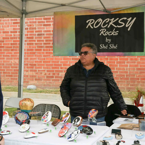 Rocksy Rocks painted rock vendor talking with a visitor at Webster's street fair