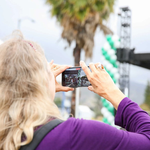 Guest photographing the stage at Webster's centennial celebration