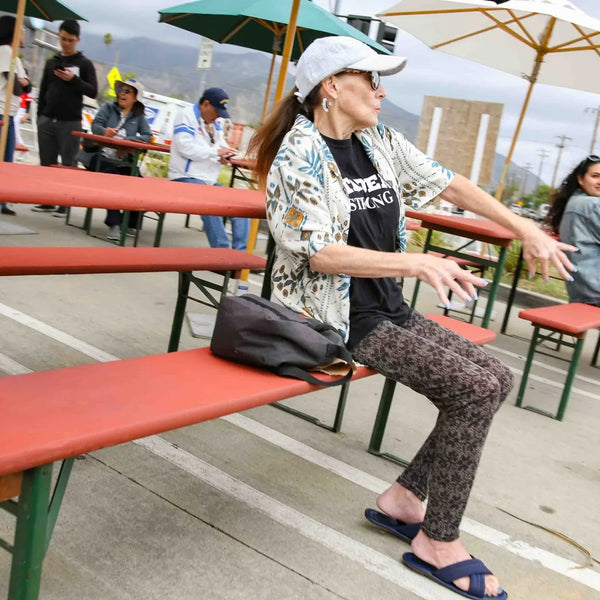Guest relaxing on a picnic bench at Webster's 100th anniversary street fair