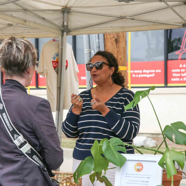Plant vendor talking with a customer at Webster's 100th anniversary fair