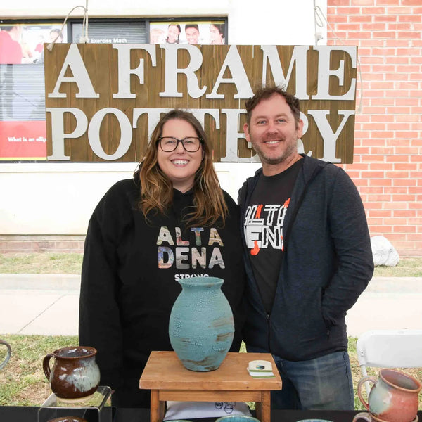 A Frame Pottery makers with their ceramics at Webster's 100th anniversary fair