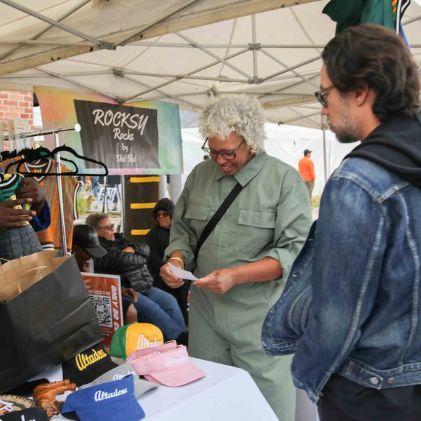 Shoppers browsing the Rocksy Rocks table at Webster's centennial street fair