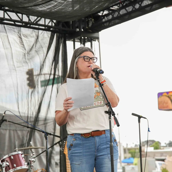 Speaker addressing the crowd from the stage at Webster's centennial celebration in Altadena