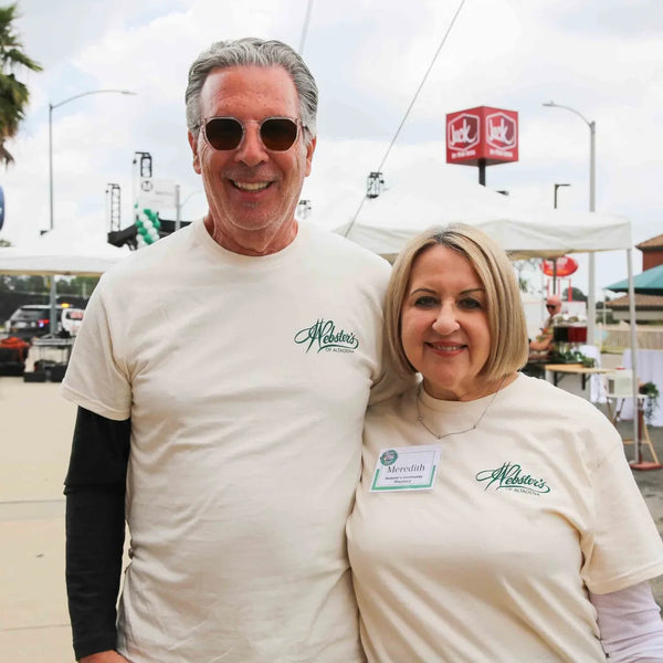 Two Webster's Pharmacy team members smiling at the 100th anniversary street fair in Altadena