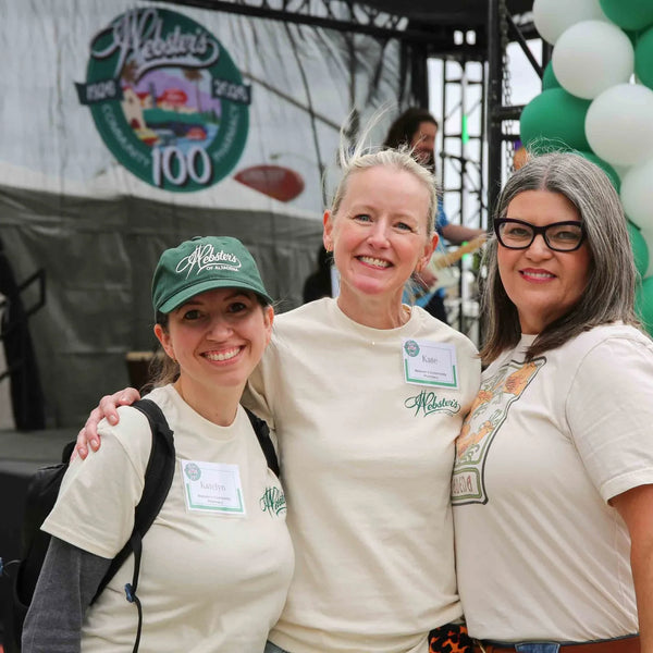 Webster's team members posing by the balloon arch at the centennial stage