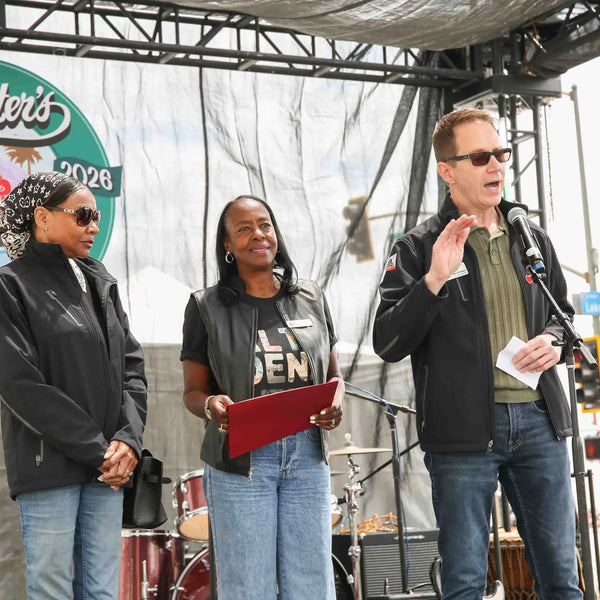 Community leaders sharing remarks on stage at Webster's 100th anniversary celebration