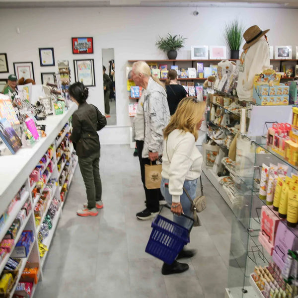 Customers shopping the candy and gift aisles inside Webster's Community Pharmacy