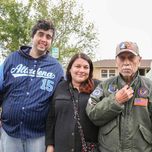 Three friends posing together at Webster's 100th anniversary street fair
