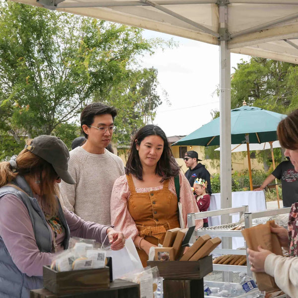Volunteers handing out treats at Webster's anniversary street fair in Altadena