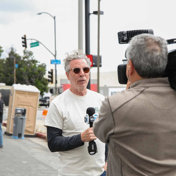 Guest interviewed on camera at Webster's 100th anniversary street fair