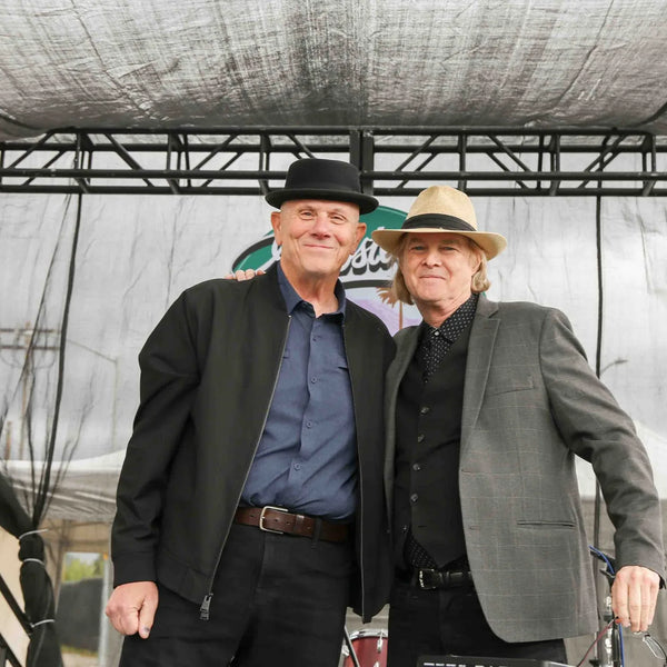 Two gentlemen in hats posing on stage at Webster's centennial celebration