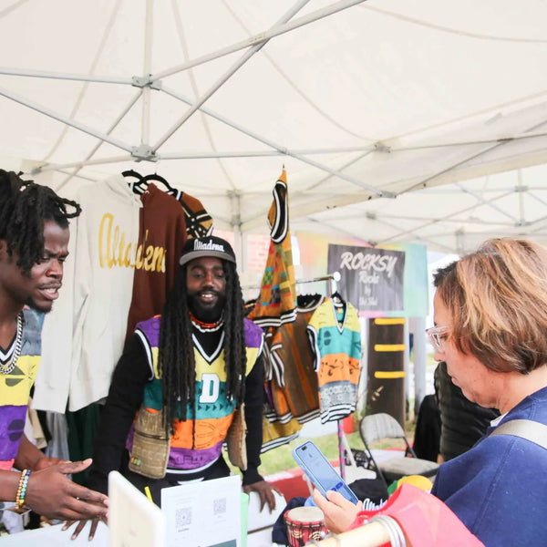 Vendors welcoming visitors to their booth at Webster's Pharmacy street fair in Altadena