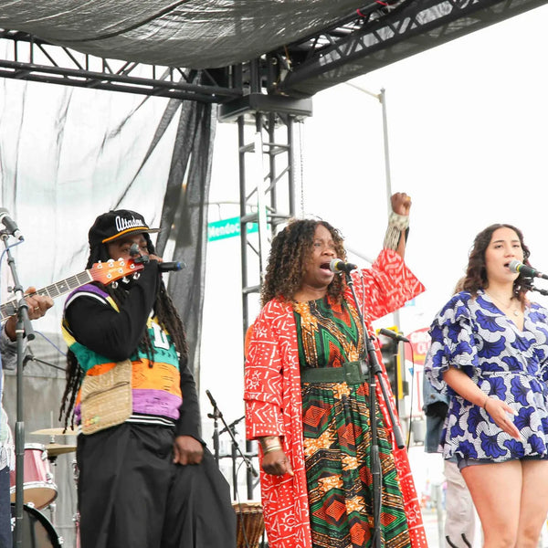 Vocal group performing on stage at Webster's anniversary street fair
