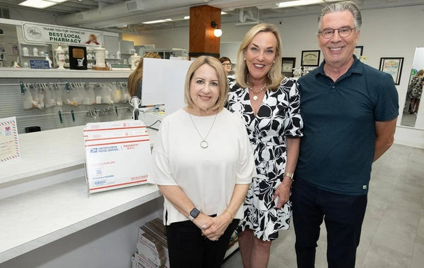 Meredith and Michael Miller with Supervisor Kathryn Barger at the new post office counter inside Webster's.